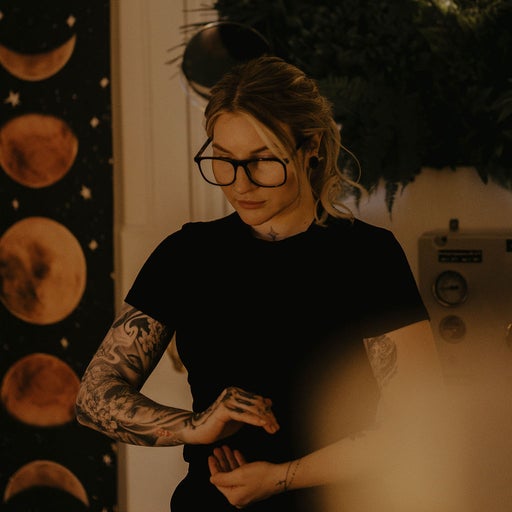 Amiee at The Sage Clinic, in front of the moon-phase wall hanging