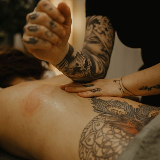 Amiee applying focused deep tissue massage to a client's back