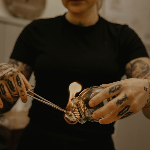 Amiee preparing a glass cup with flame for fire cupping